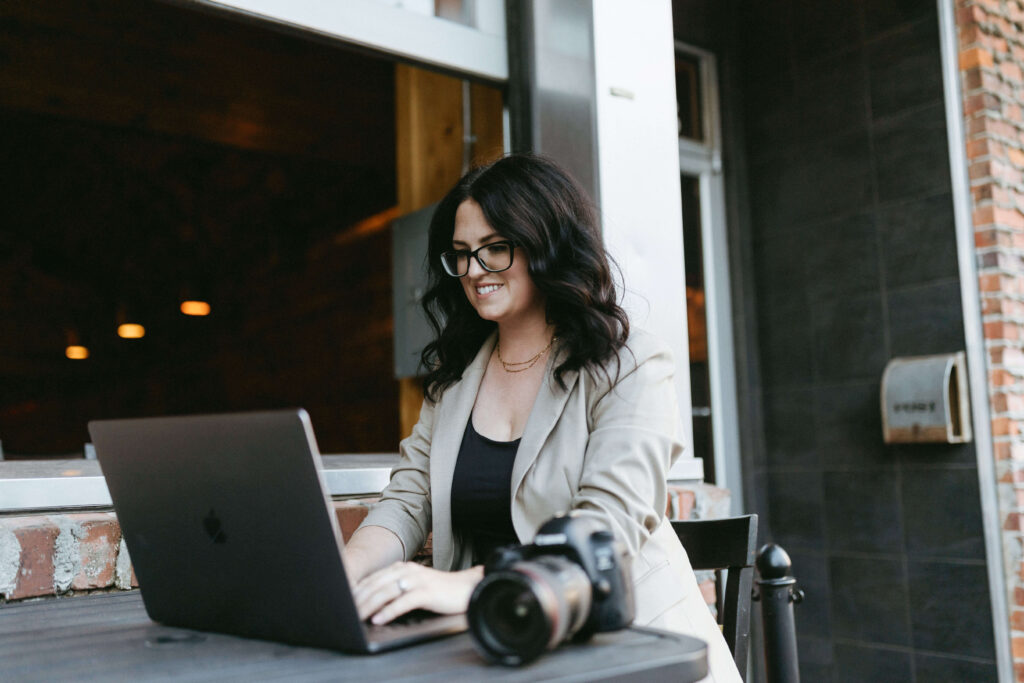 Marissa Chrzan sitting at a laptop teaching how to learn to create a new catalog in Lightroom